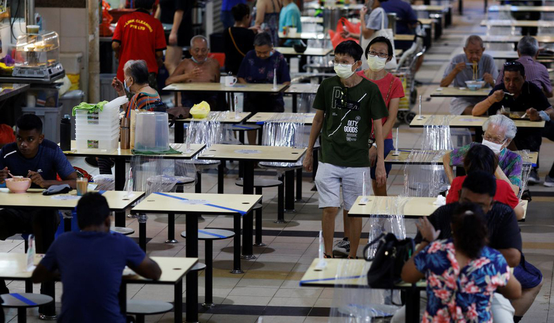 People eat at a hawker centre in Singapore